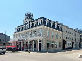 Kingston apartment for rent - A large building with a clock tower and a sign that says "The Rose Room".