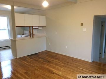 Kingston apartment for rent - an empty living room with a hard wood floor