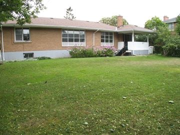 Kingston apartment for rent - A house with a green lawn in front.