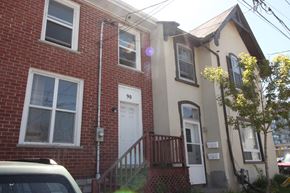 Kingston apartment for rent - the front of a brick house with a white door