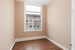 Kingston apartment for rent - A room with a window showing a view of a building with the word "Champion" on it.