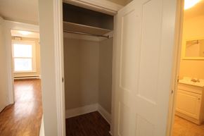 Kingston apartment for rent - a bedroom with a closet and a hallway to a bathroom