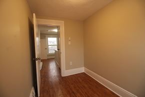 Kingston apartment for rent - a living room with a hard wood floor and a door to a hallway