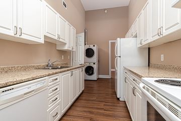 Kingston apartment for rent - A kitchen with white cabinets and appliances.