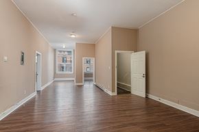 Kingston apartment for rent - A long hallway with a white door at the end.