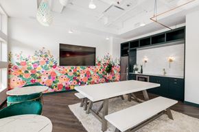 Calgary apartment for rent - A dining room with a white table and a green chair.