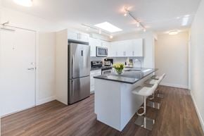 North Vancouver apartment for rent - a kitchen with white cabinetry and stainless steel appliances
