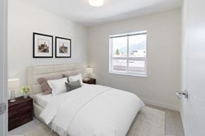 North Vancouver apartment for rent - a bedroom with a large bed and two night stands with lamps