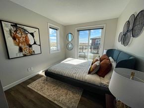 Calgary townhouse for rent - an overview of a bedroom with a bed and a window