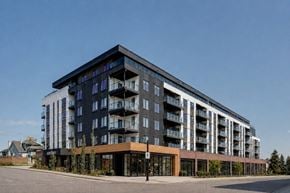 Calgary apartment for rent - A modern multi-story building with balconies on the upper floors.