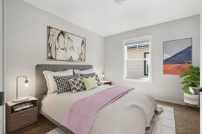 Cochrane apartment for rent - a bedroom with a large bed and a window