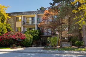 White Rock apartment for rent - a brick apartment building with balconies and a no parking sign in front of it