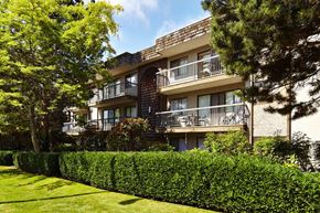 White Rock apartment for rent - an apartment building with balconies and a manicured lawn