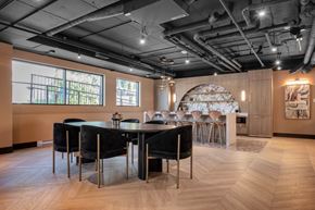 Calgary apartment for rent - A modern dining room with a large table and chairs.