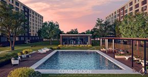 Richmond apartment for rent - A pool surrounded by a deck and trees with a building in the background.