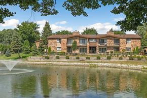 Downers Grove apartment for rent - A building with a fountain in front of it.