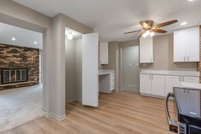Downers Grove apartment for rent - A modern kitchen with a wood stove and white cabinets.