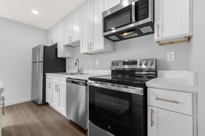 Downers Grove apartment for rent - A modern kitchen with stainless steel appliances and white cabinets.