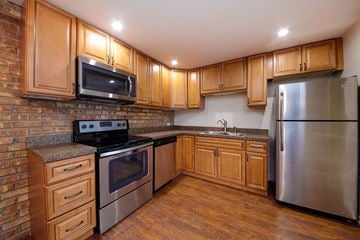 Downers Grove apartment for rent - A kitchen with wooden cabinets and stainless steel appliances.