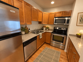 Chicago apartment for rent - A kitchen with wooden cabinets and stainless steel appliances.