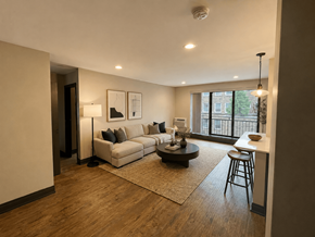 Chicago apartment for rent - A living room with a white couch, a coffee table, and a window.