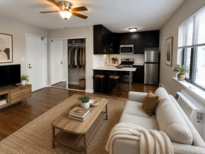 Chicago apartment for rent - A living room with a couch, a coffee table, and a ceiling fan.