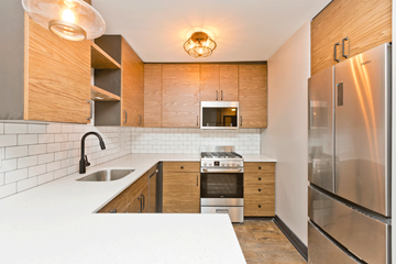 Chicago apartment for rent - A modern kitchen with wooden cabinets and stainless steel appliances.