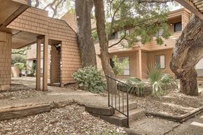 San Antonio apartment for rent - A brick house with a tree in front.