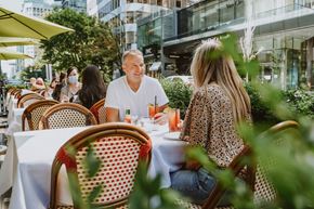 Vancouver apartment for rent - A man and a woman are sitting at a table in an outdoor cafe.