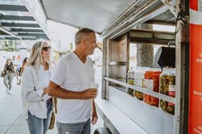 Vancouver apartment for rent - A man and a woman are standing in front of a food truck.