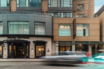 Vancouver apartment for rent - A car is driving past a building with a sign that says Brooks Brothers.