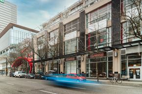 Vancouver apartment for rent - A blurred blue car is in motion on a city street.