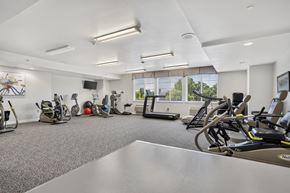 Lakewood apartment for rent - A well-lit gym with various exercise equipment.