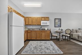 Lakewood apartment for rent - A kitchen with wooden cabinets and a white refrigerator.