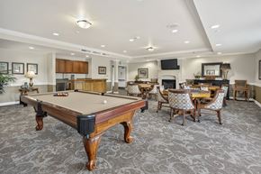 Lakewood apartment for rent - A pool table is in the middle of a room with a carpeted floor.