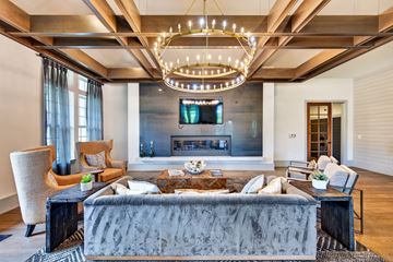 Ponte Vedra apartment for rent - A modern living room with a grey sofa and a chandelier.