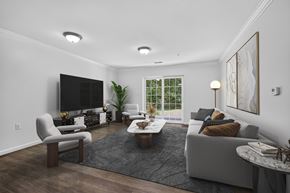 Glenmont apartment for rent - Modern living room with gray sofa and large tv at Glenmont Abbey Village Apartments, Glenmont, 12077