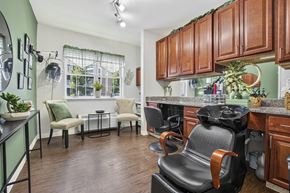 Glenmont apartment for rent - A kitchen with brown cabinets and a black chair.