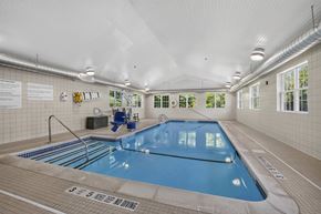Glenmont apartment for rent - A large indoor swimming pool with a blue tiled edge and a white ceiling.