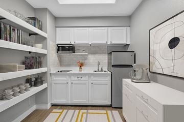 King City apartment for rent - A kitchen with white cabinets and a grey backsplash.