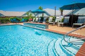 Denton townhouse for rent - A swimming pool with a blue tiled edge and a metal ladder on the right side.