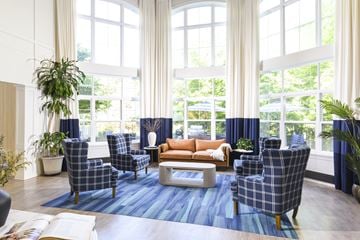 Fort Washington apartment for rent - A living room with a blue rug and plaid chairs.