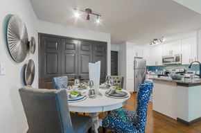 Denton townhouse for rent - A modern dining room with a white table and blue chairs.
