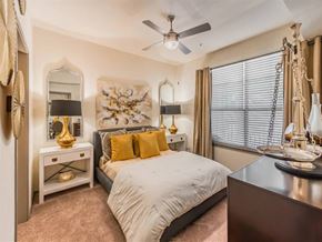 Lewisville apartment for rent - A bedroom with a bed, a dresser, and a mirror. at Haven at Lewisville Lake Apartments, Lewisville, FL, 75077