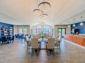 Lewisville apartment for rent - A spacious dining area with tables and chairs. at Haven at Lewisville Lake Apartments, Florida, 75077
