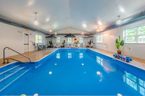 Utica apartment for rent - Indoor swimming pool with seating area at Schuyler Commons Apartments, Utica, New York