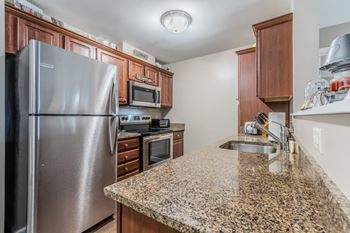 Modern kitchen with granite countertops and stainless appliances