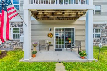 Covered patio with chairs and sliding door entrance