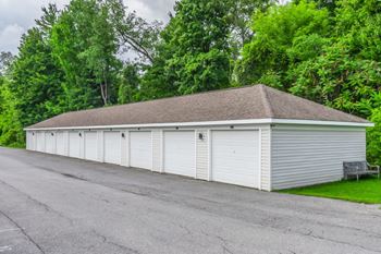 White storage unit building with multiple garage doors