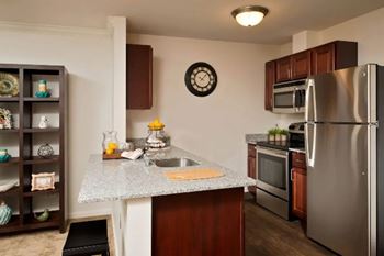 Modern kitchen with granite counters and dark cabinets